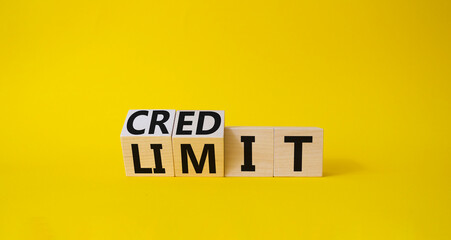 Credit and limit symbol. Turned wooden cubes with words credit and limit. Beautiful yellow background. Business and Credit limit concept. Copy space