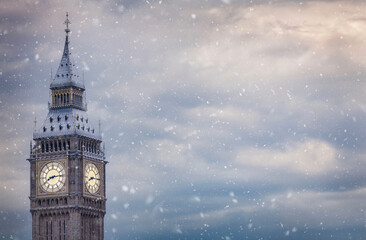 The ice covered Elizabeth Tower or so called Big Ben at Westminster Palace in London with snow and...