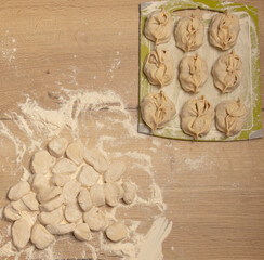 Cooking dough with meat on the table.