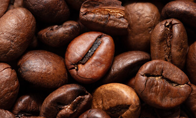 Grains of black coffee as a background.