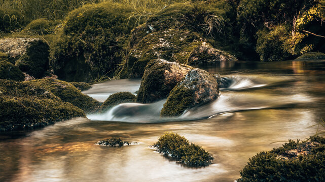 Horizontal photo of the mountain river Kwisa near Świerad&oacute;w-Zdr&oacute;j in Poland. The long exposure caused the water to blur.
