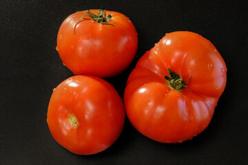 RED TOMATOES ON A DARK BACKGROUND