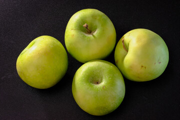GREEN APPLES ON A DARK BACKGROUND