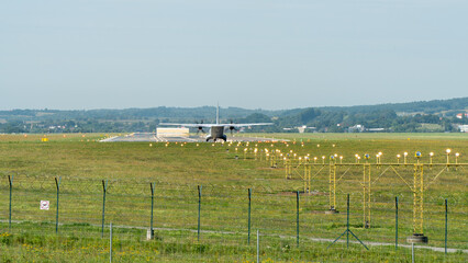 A plane taking off, positioned at the beginning of the runway - obrazy, fototapety, plakaty