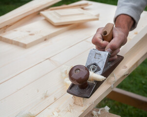Working with hand plane. Joiner's (carpenter's) tool.