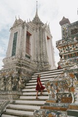 tourist girl at arun temple in bangkok, thailand