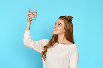 curly brunette woman with drinking glass of water