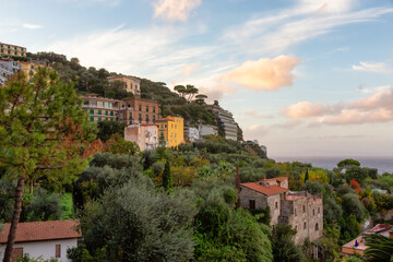 Fototapeta na wymiar Rocky Coast and Homes in Touristic Town, Sorrento, Italy. Amalfi Coast. Colorful Sunset Sky