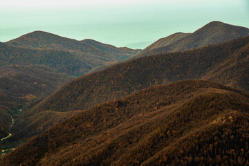 Stunning view from the top of Mount Peus in the Northwest Caucasus. View from a height of 1000 m to the peaks of the Black Sea coast of the Caucasus.