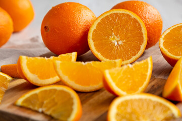 Raw Organic Orange Fruit on a white wooden background, side view.
