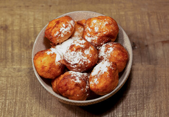 bowl with oliebollen for new years eve - bowl with deep fried doughnut balls, a dutch tradition