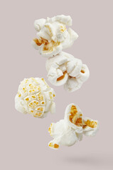 Flying delicious popcorn, isolated on pastel background