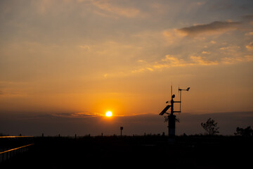 Meteo station against the setting sun. Elements of the continuous weather monitoring system