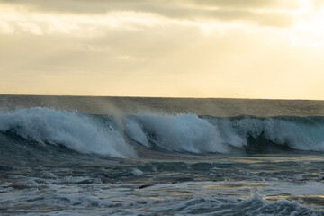 Huge waves on a beautiful morning in Madeira, Portugal. Great sunrise and a beautiful yellow sky...