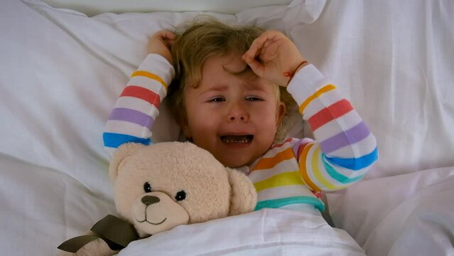 children are crying in bed. selective focus.