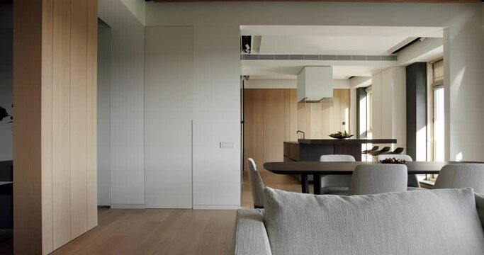 Light Wood Wall and Floors.Modern kitchen and bar brown chairs in kitchen room.Modern Kitchen room with minimalist dining table.Minimalist kitchen room in white colors with dining area of natural wood