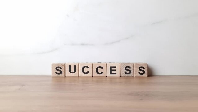 Success word from wooden cubes. Motivation, business challenge, progress, strategy concept