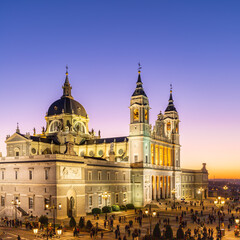 Naklejka na ściany i meble Madrid, Spain 28-12-2022 The Almudena Cathedral during a colorful sunset, it is the most important and Catholic religious building in Madrid and a visit is free of charge except for the crypt 