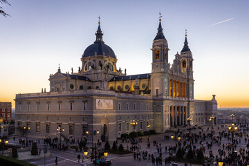 Naklejka premium Madrid, Spain 28-12-2022 The Almudena Cathedral during a colorful sunset, it is the most important and Catholic religious building in Madrid and a visit is free of charge except for the crypt 