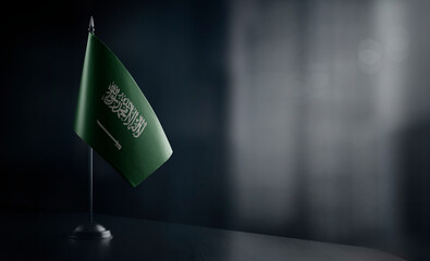 Small national flag of the Saudi Arabia on a black background