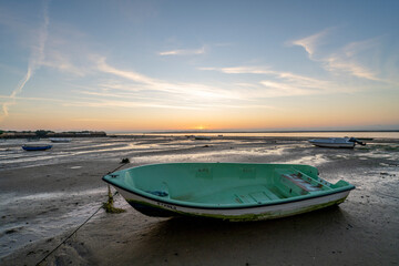 Fisherboat on the shore during sunrise in Olhao, Portugal
