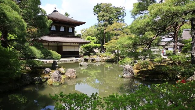 Scenic landscape of pond in springtime and architecture of Kannon-Hall in Ginkakuji Temple. Ginkaku-ji or Silver Pavilion, officially Jisho-ji, is a Zen temple in Higashiyama District, Kyoto, Japan.