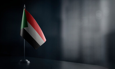 Small national flag of the Sudan on a black background