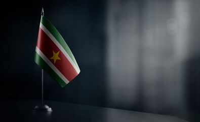 Small national flag of the Suriname on a black background