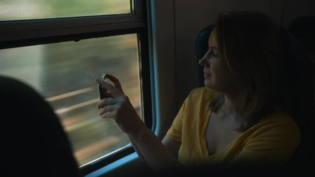 Woman shooting video of her trip inside the train.