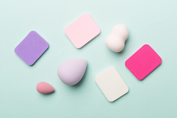 Beauty blenders on color background, top view