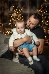 parent with child near christmas tree