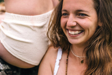 Two girls in underwear posing outdoors in the garden. Close-up portrait of a laughing girl