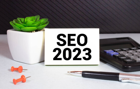 SEO 2023. text on a notebook and on wooden blocks.