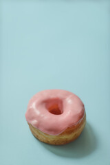Pink Iced Donut on Light Blue Background
