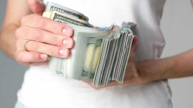 A stack of money in the hands of a man close-up