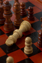 Conceptual image: fallen king on the chessboard