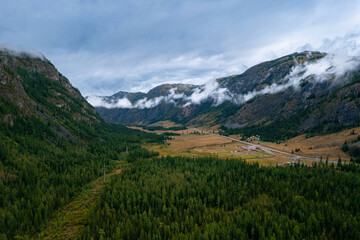 Aerial landscape Altai melancholic mood, blue geyser lake with forest Aktash mountains, Altay...