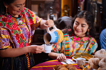 A family gathers at home for a celebration with a traditional party dish.
