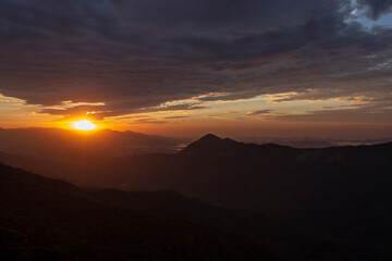 Sun rising over the clouds, in the hills. Immigrants highway, Santos, Sao Paulo state, Brazil