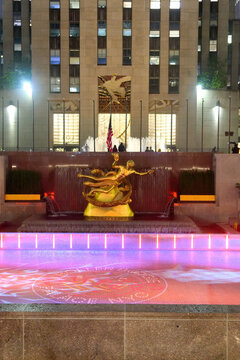 Colored Lights On Rockefeller Center Prometheus Statue And Ice Rink