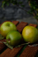 Green apples on a wood tray