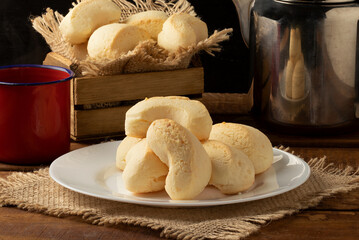 Traditional cheese biscuit and coffee on table.