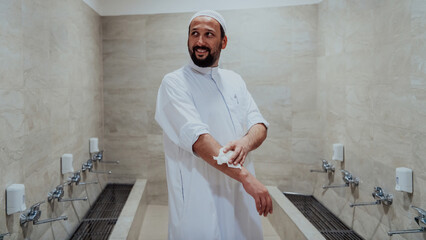 A portrait of a man in abdesthana using a towel