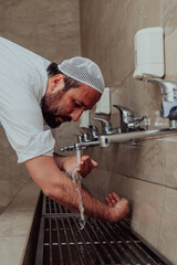 A Muslim performing ablution. Ritual religious cleansing of Muslims before performing prayer. The...