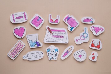 Woman`s health. Different paper figures on beige background, flat lay