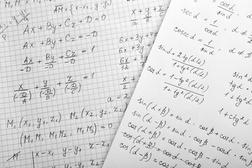 Sheets of paper with different mathematical formulas, top view