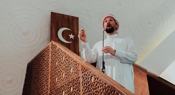Muslims arabic Imam has a speech on friday afternoon prayer in mosque. Muslims have gathered for the friday afternoon prayer in mosque and are listening to the speech of imam