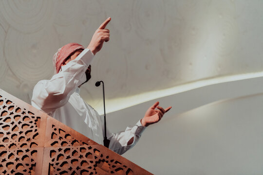 Muslims arabic Imam has a speech on friday afternoon prayer in mosque. Muslims have gathered for the friday afternoon prayer in mosque and are listening to the speech of imam