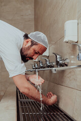 A Muslim performing ablution. Ritual religious cleansing of Muslims before performing prayer. The...
