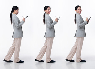 Full Length 20s Asian Woman wear formal business blazer suit  dress pant shoes. Black long straight hair female hold tablet work confident, walking forward turn left right, white background isolated